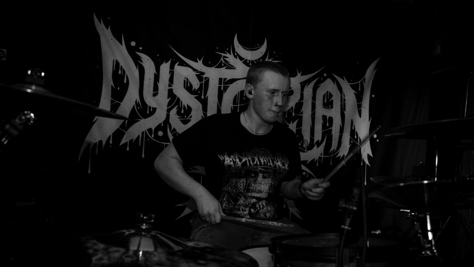 Diggity Glover performing live in front of the Dystopian Sun banner