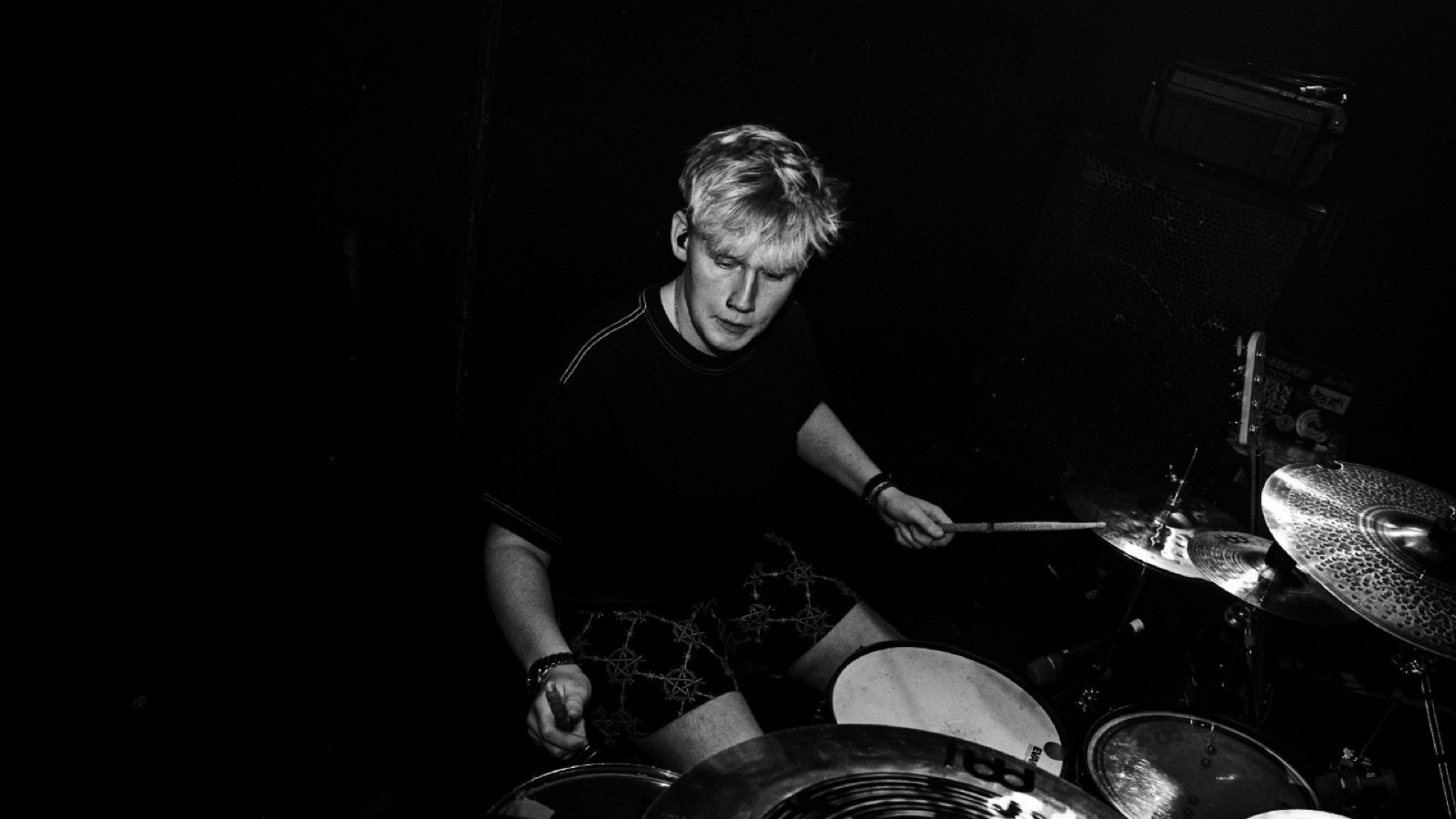 Black and white live drumming performance photo of Diggity Glover