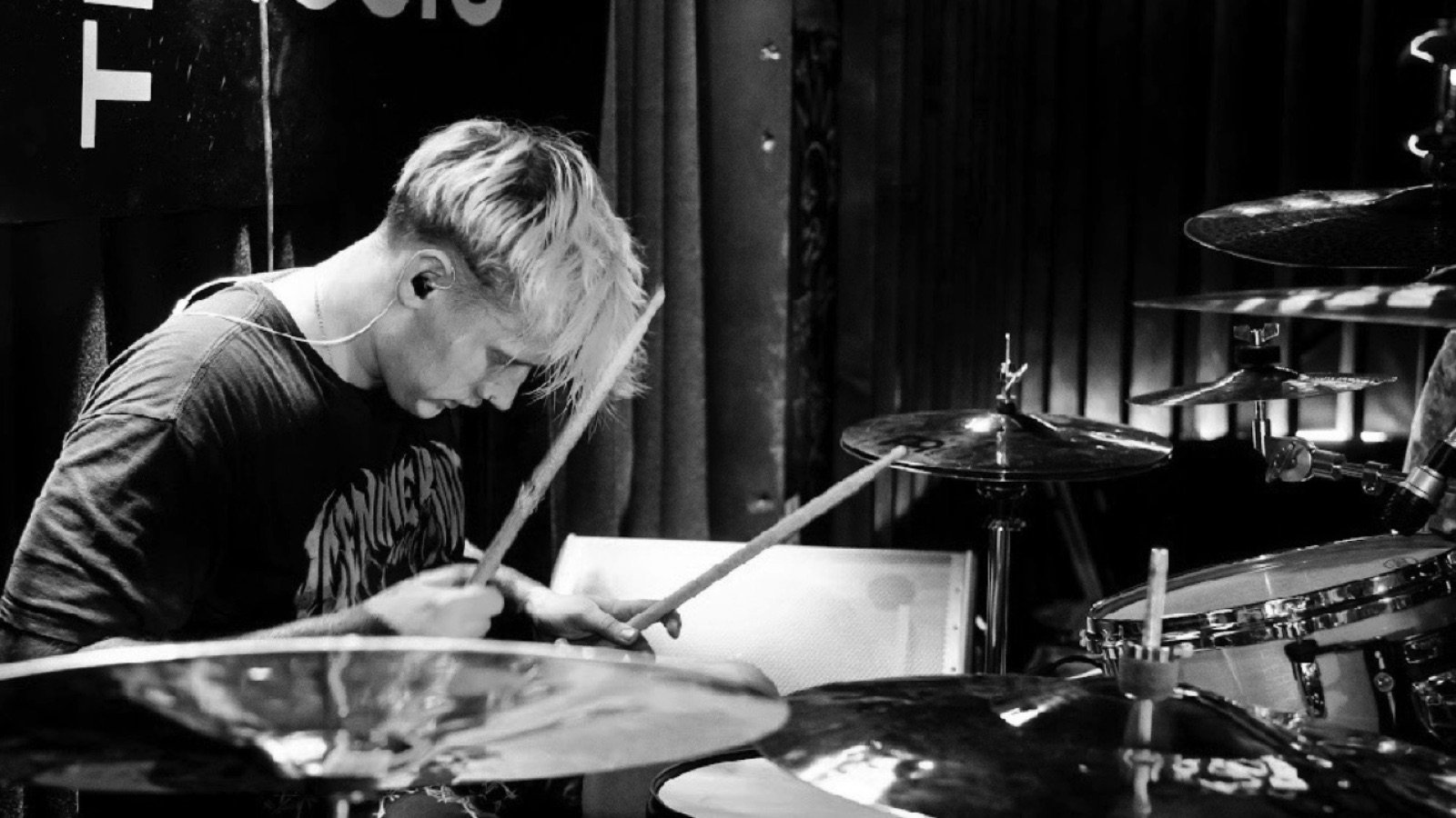 Diggity Glover mid-performance behind the kit, side profile