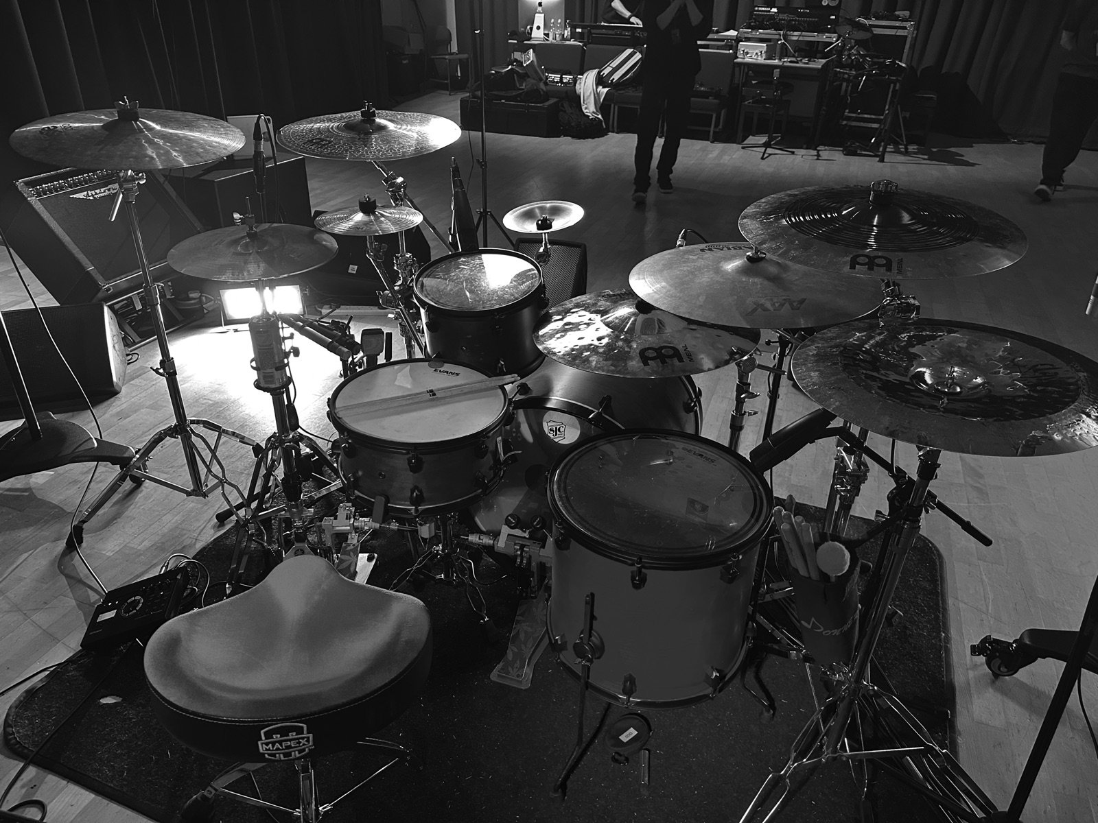 Full drum kit on stage before a live performance, black and white